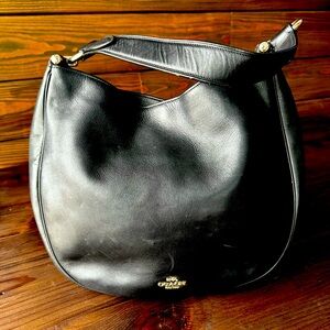 Authentic Coach shoulder bag, black leather with silver accent.